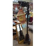 A carved hardwood standard lamp,