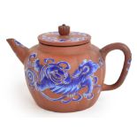 An 18th/19th century Chinese Yixing teapot of lobed globular form, painted in blue enamels with