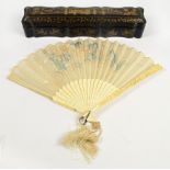 An early 20th century Chinese Canton carved ivory and silk embroidered fan, the guard sticks