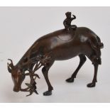 A Chinese Ming Dynasty bronze censer modelled as a slender buffalo with a monkey finial and a