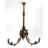 A gilt metal light fitting, the fluted turned central column to three winged figural mounts,