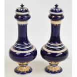 A pair of late 19th/early 20th century Meissen vases and covers, each gilt heightened on a cobalt