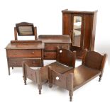 An early 20th century oak doll's bedroom suite comprising mirrored wardrobe, height 51cm,