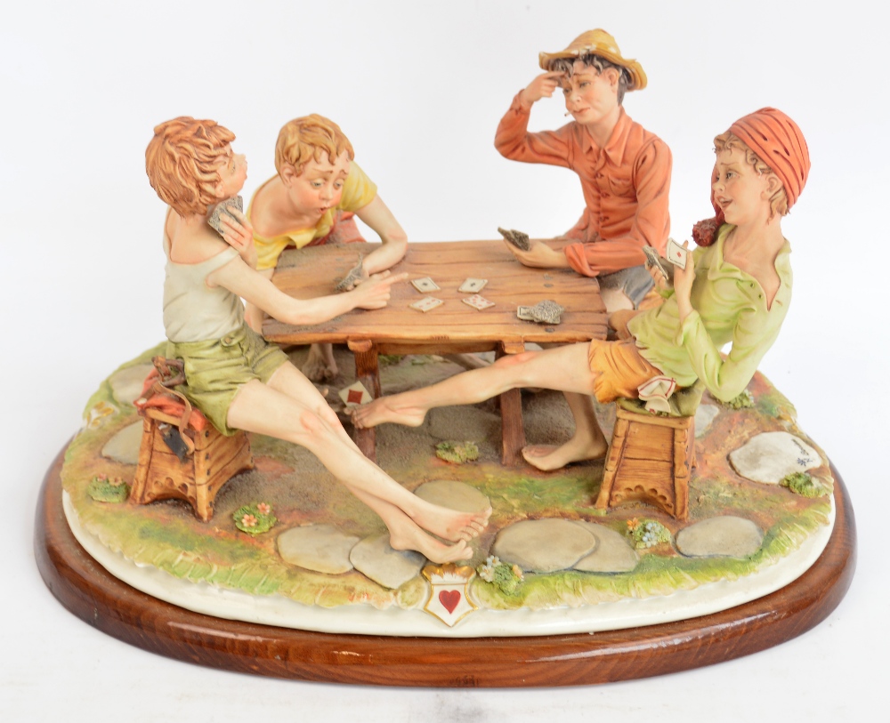 A large Capodimonte figure group, the card players, incised to base "Corlese" and on wooden plinth,