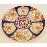 A large early 20th century Japanese Imari decorated charger decorated with panels of birds amongst