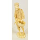 A Japanese Meiji period ivory sectional okimono of a farmer holding a basket and a tool,