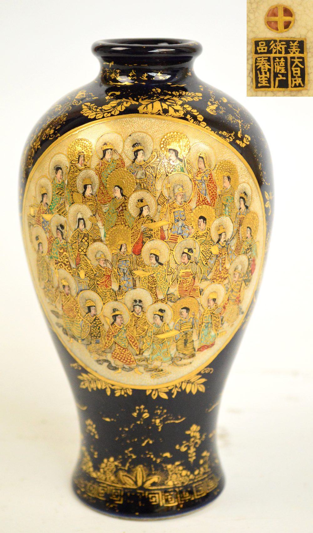 A Japanese Meiji period baluster vase, finely painted with two oval panels depicting haloed