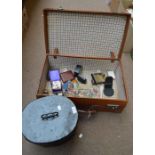 A suitcase, hat tin, vanity box and various boxes.
