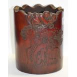 A decorative 20th century Chinese bamboo brush pot with shaped rim and carved with a boy on a