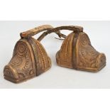 A pair of Argentinian gaucho stirrups with floral carved decoration,