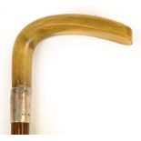 An Edwardian horn handled walking cane with hallmarked silver collar, London 1906.
