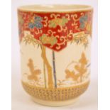 A Japanese Meiji period Satsuma beaker decorated with a continuous landscape between floral sprays