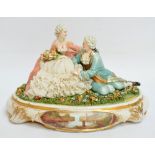 A 1950s Capodimonte figure group of two lovers with lace embellished clothing, on a plinth, signed