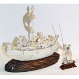 An early 20th century Chinese carved ivory model of a boat set with four figures and mounted on a