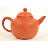 A 19th century Chinese Yixing spherical teapot, impressed seal mark to base, length 19.5cm.