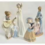A large Nao figure of a girl with a guitar, a Nao figure group of a girl brushing the hair of