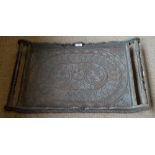 A profusely carved decorative Indian rectangular tea tray with scrolling handles, width 71cm.