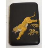 A Meiji period Japanese Komai cigarette case decorated to the front with a leaping tiger over bamboo