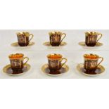 A set of six Bohemian porcelain coffee cups and saucers with gilt interiors, decorated with