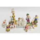 A collection of Continental porcelain figures including a pair by Augustus Rex of a young boy