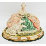 A 1950s Capodimonte figure group of a seated lady with lace trimmed ornate dress holding a bouquet