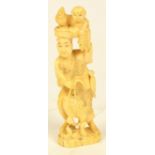 A Japanese ivory one-piece okimono depicting a farmer with a basket of fruit and a boy with a