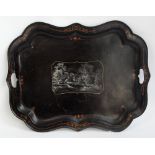 A late 19th century tole-ware tray of shaped form centred with a cottage landscape, 61 x 47cm.