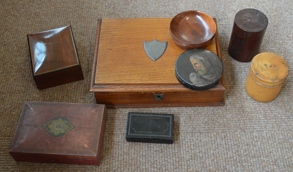 A 19th century papier-mâché circular snuff box, a further rectangular snuff box, an oak trinket box,