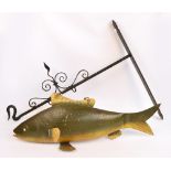 An unusual painted tin fish hanging sign, suspended on a wrought iron wall mounted scrolling