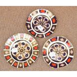A Royal Crown Derby Imari decorated plate; 1128, and a pair of matching shallow bowls.