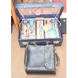 An Art Deco lady's travelling vanity suitcase with lift-out tray enclosing various glass bottles,