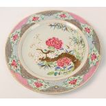 An 18th century Chinese Export porcelain charger painted in Famille Rose enamels with chrysanthemum,