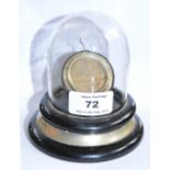 A pocket watch stand under a hinged glass dome on ebonised socle base, height 11cm.