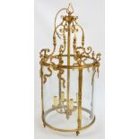 A gilt metal cylindrical ceiling light with scroll and ribbon decoration, height 84cm.