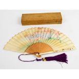 A cased Japanese late Meiji period bamboo, ivory and paper fan,