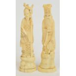 A pair of early 20th century Japanese ivory okimono depicting officials, on oval bases, height 18cm.