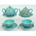 A decorative 20th century Chinese porcelain tea for two set comprising teapot, sugar bowl and stand,