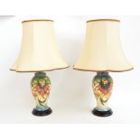 A pair of Moorcroft baluster shaped lamp bases in the "Anna Lily" pattern with shades,