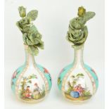 A pair of early 20th century Continental porcelain bottle vases, each with four panels separated