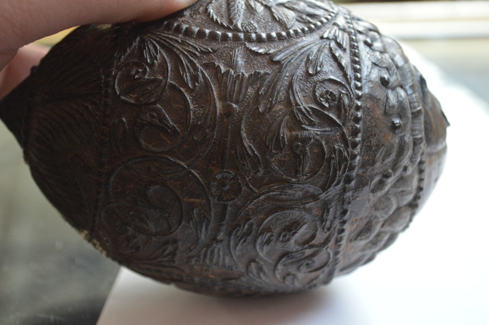 An unusual carved coconut with mask detail to the front and band of scrolling decoration with - Image 5 of 6