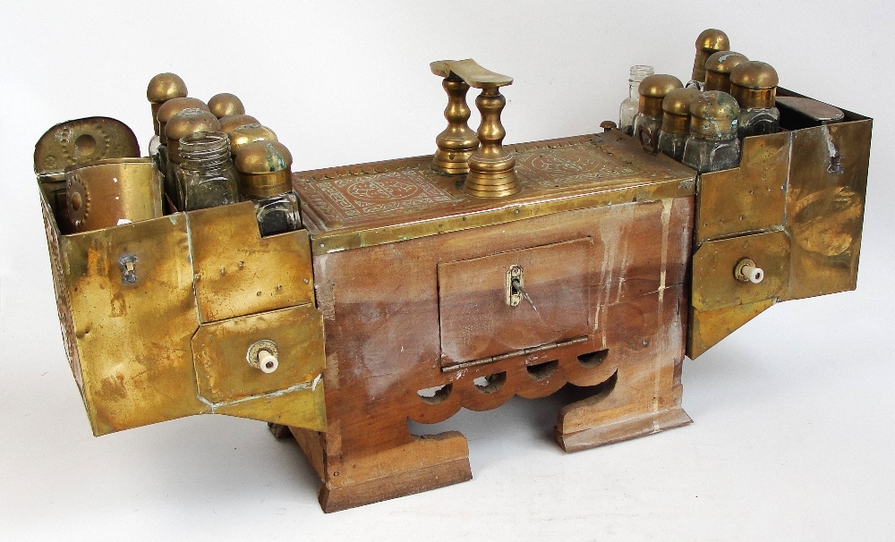 A late 19th century large Turkish brass shoe shine box stand, ornate side facing customer,