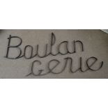 Three sections of wrought iron lettering spelling "Boulangerie".