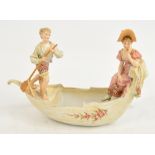 A late 19th century Continental porcelain figure group with a man and a woman in a gondola type