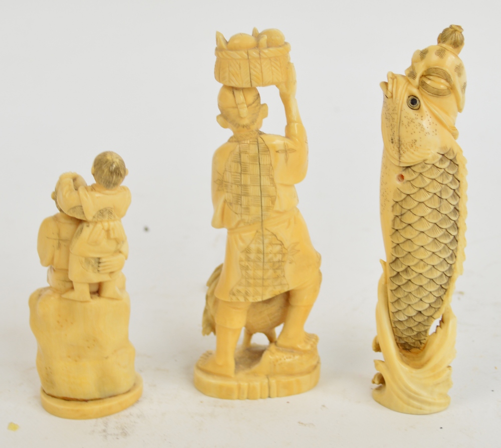 A Japanese Meiji period ivory okimono depicting a man astride an oversized carp leaping from the - Image 2 of 5