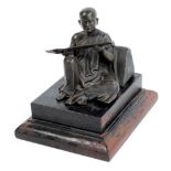 An early 20th century Burmese bronze figure of a seated Buddha reading a scroll,