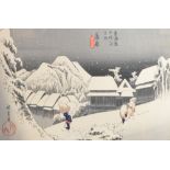 A Japanese woodblock print depicting figures in a winter landscape,