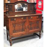 A 20th century mirror back sideboard of small proportions with incised decoration to the front