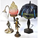 A Tiffany style lamp, a brass lamp with opaque glass shade and a gilt heightened cherubic lamp (3).
