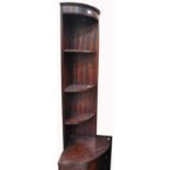 A contemporary mahogany corner unit with three shelves above cupboard section and a reproduction