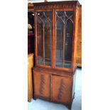 A reproduction mahogany bookcase, twin glazed doors over two cupboard doors, 180 x 77cm.